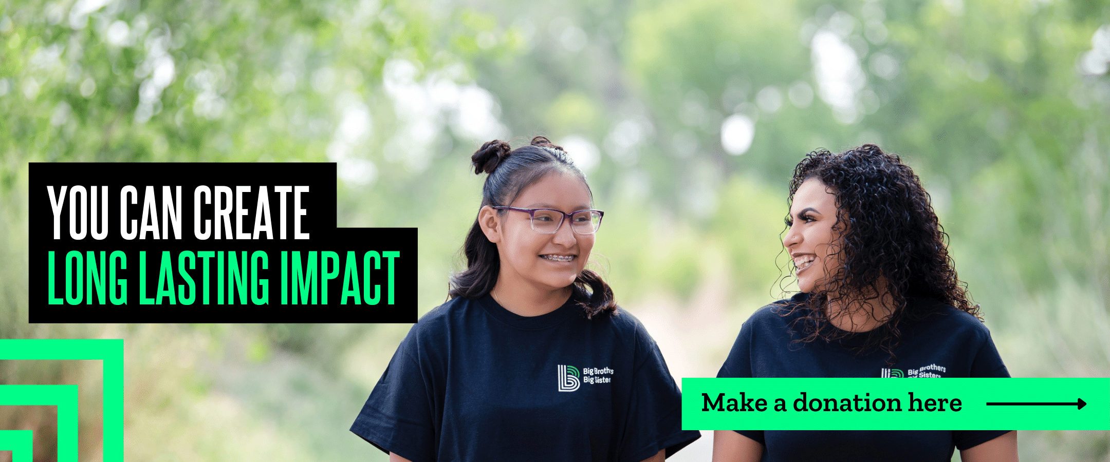An adult female mentor and a young woman smile at each other as they walk through the woods. Over this image is text that says " You can create long-lasting impact. Make a donation here."